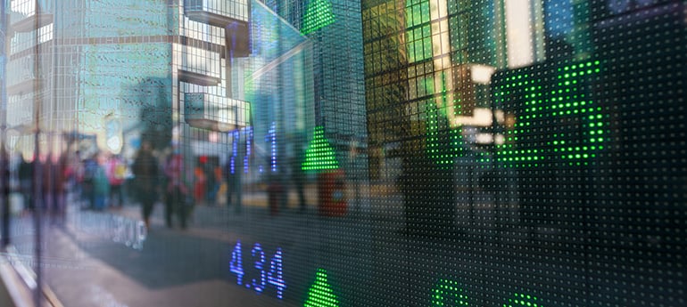 close up image of a digital display showing stock indicators